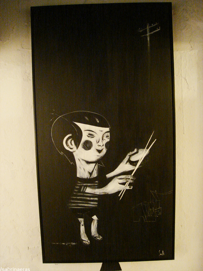 a black painting of a boy holding a scissors