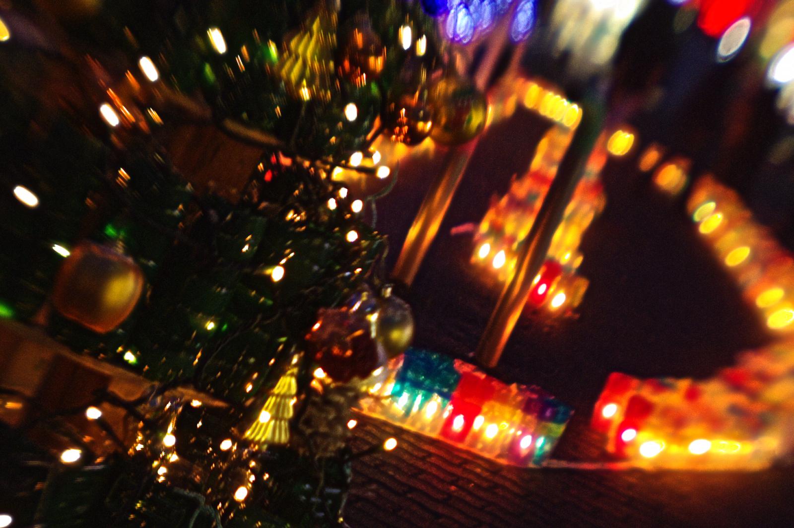 a decorated christmas tree surrounded by lights in an indoor setting