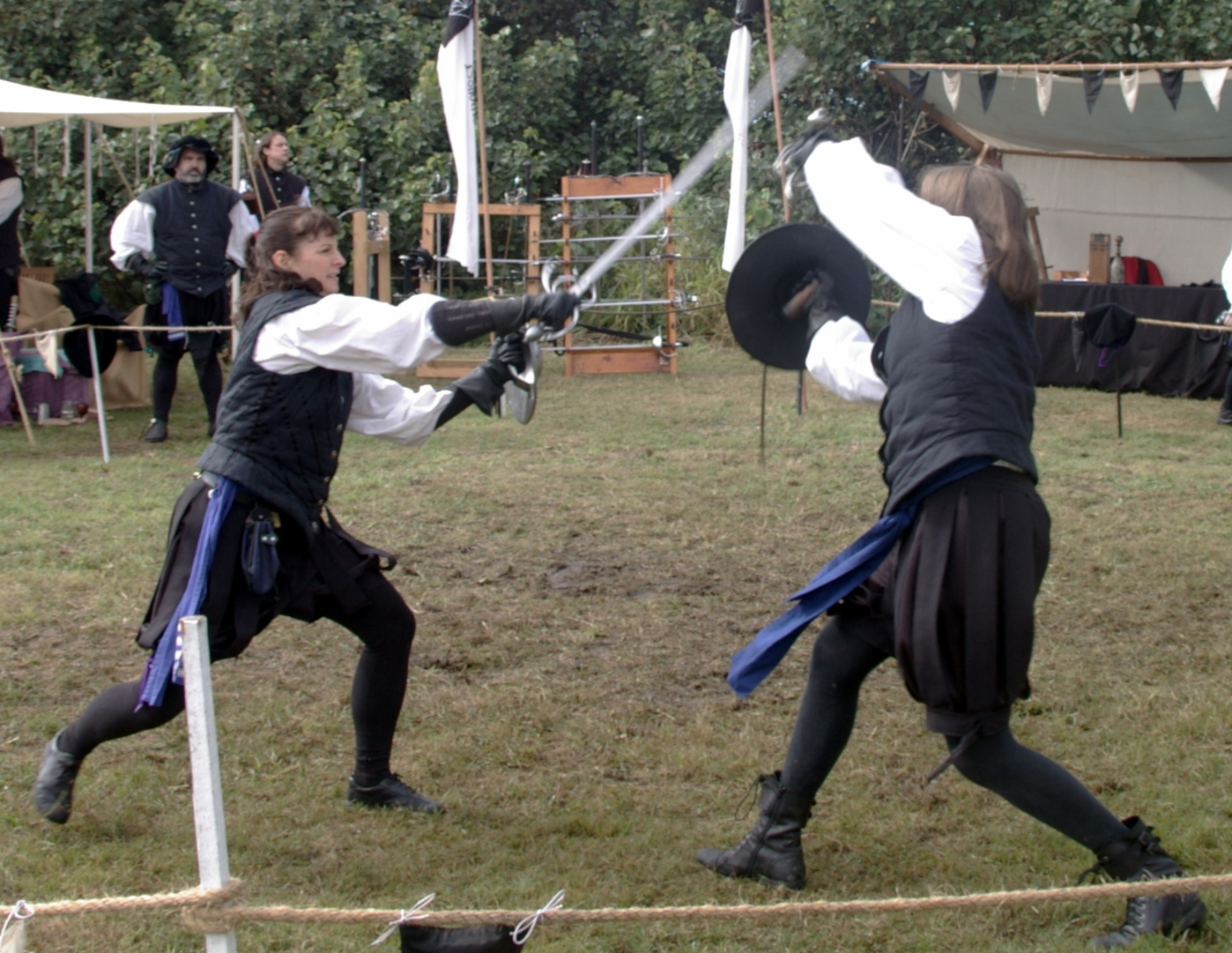 two people dressed in historical clothing playing a game