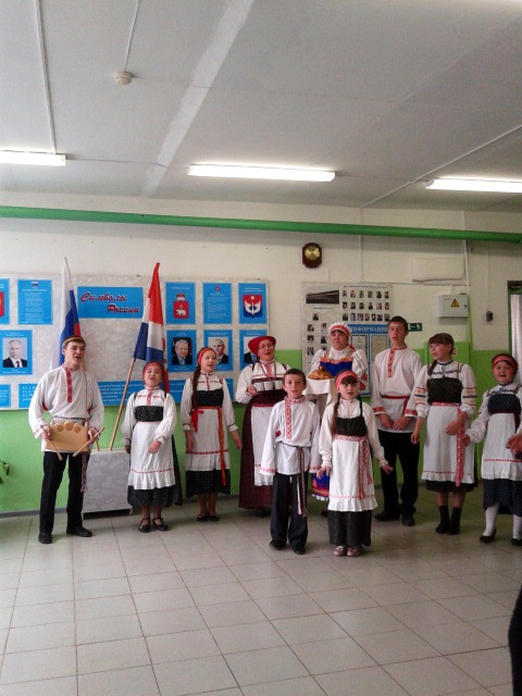 the children in aprons are singing together