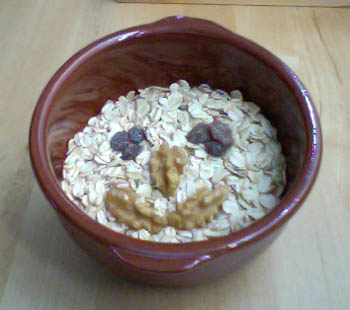 a bowl with oatmeal and granola in it