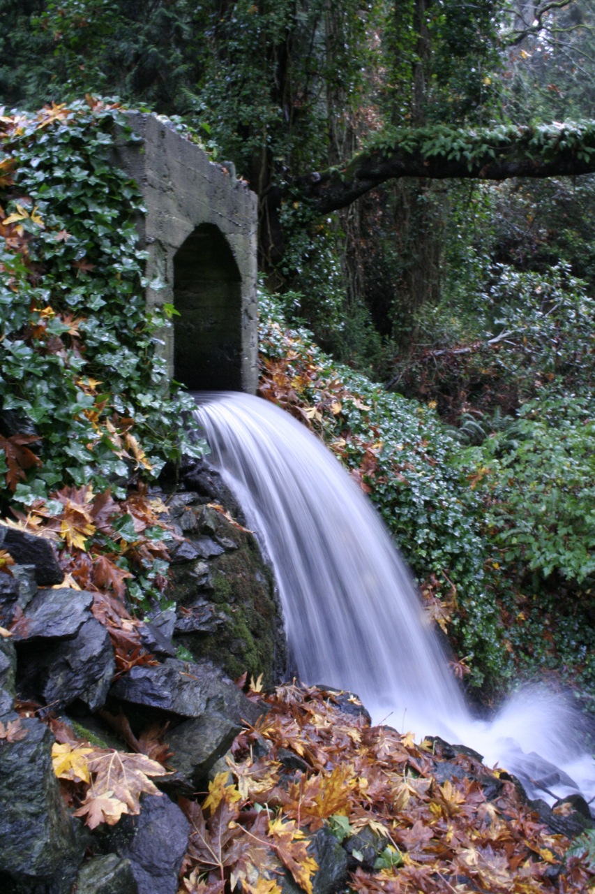 a waterfall is running down from a bridge