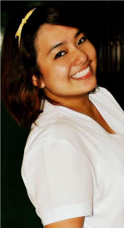 an asian woman wearing a white shirt smiling