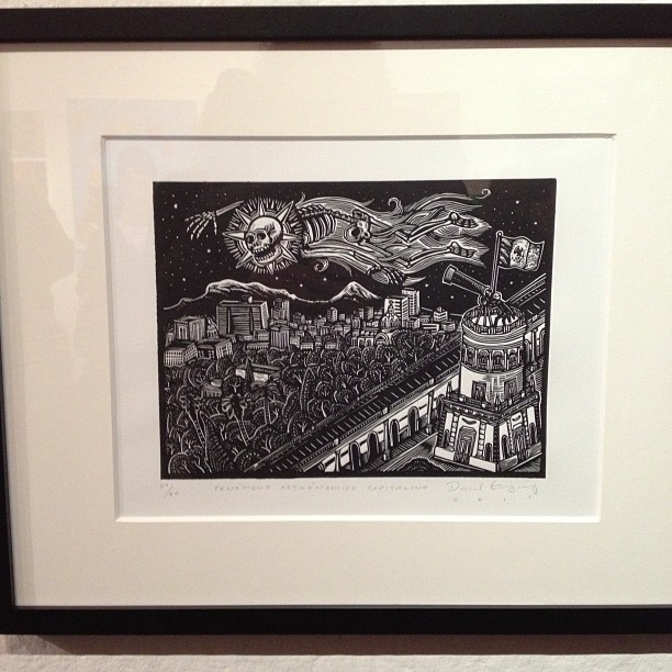 a drawing in a frame shows an illustration of the city at night