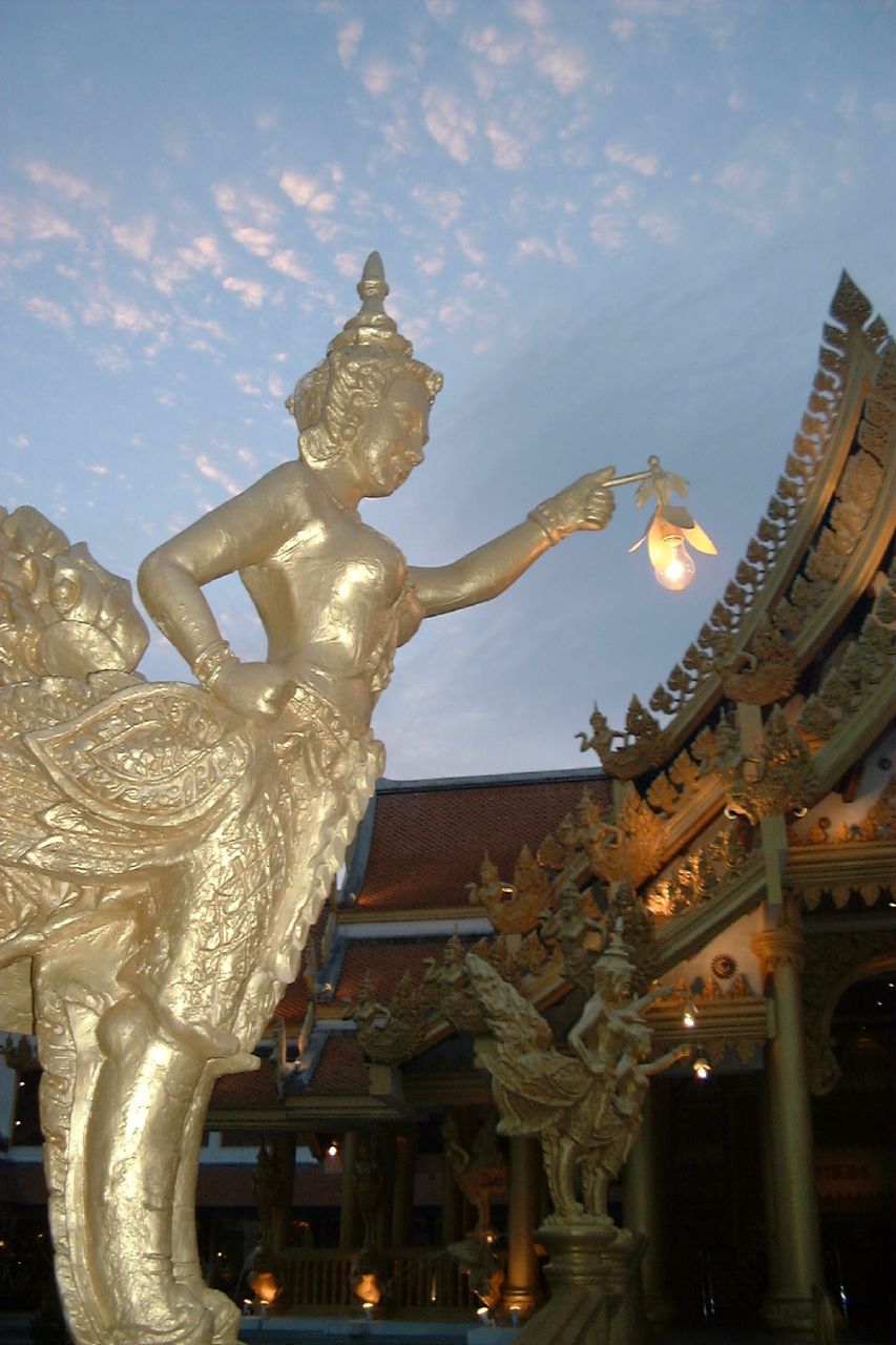 a statue is pictured with a lantern in the sky