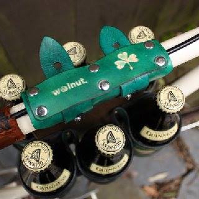 green colored bike handle with four beer bottles