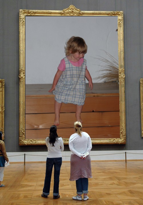 two little girls standing on a stage in front of an art piece