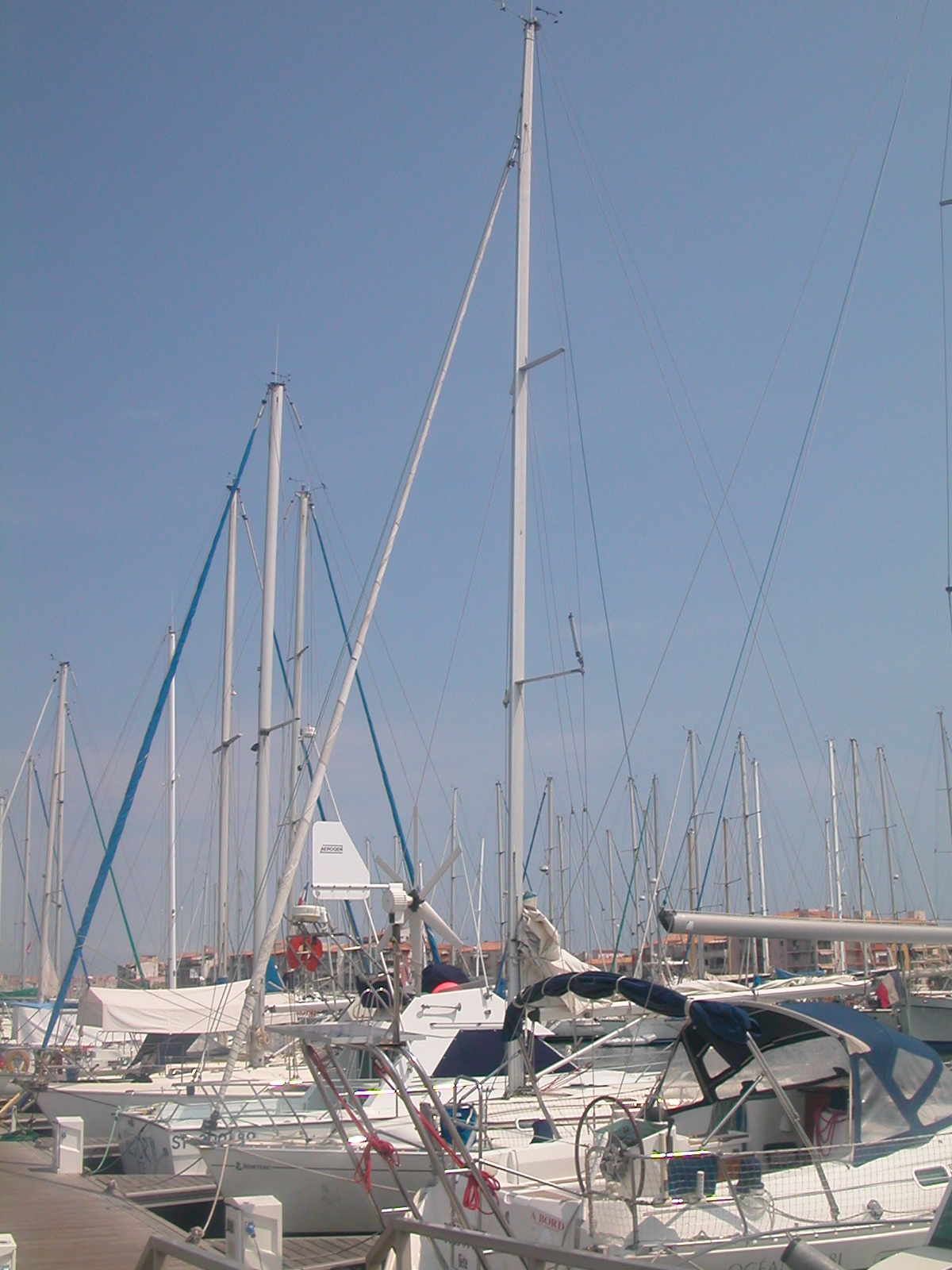 a row of white boats floating in a marina