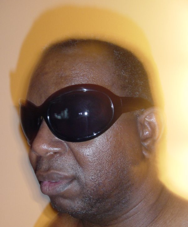 a man wearing sun glasses looking to the side