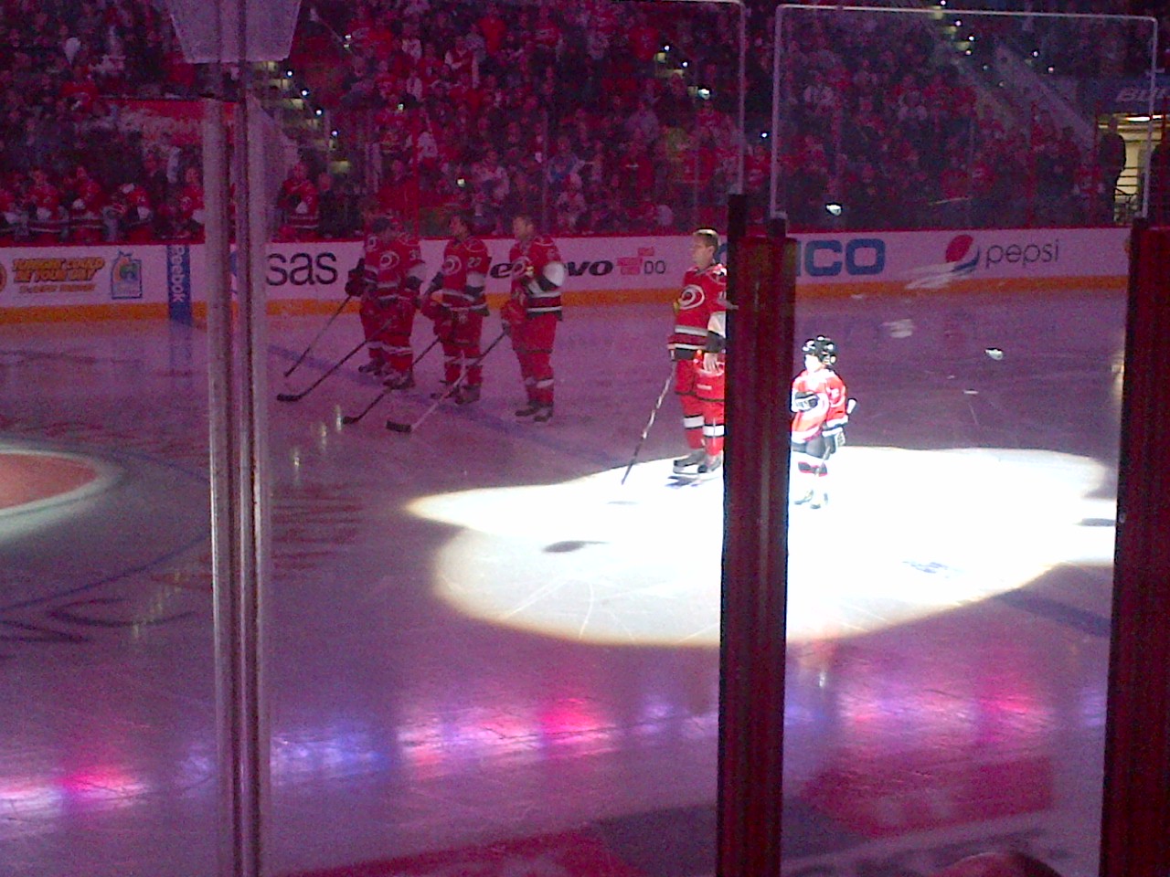 hockey players are on the ice in a stadium