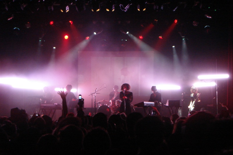 two people on stage with their arms up