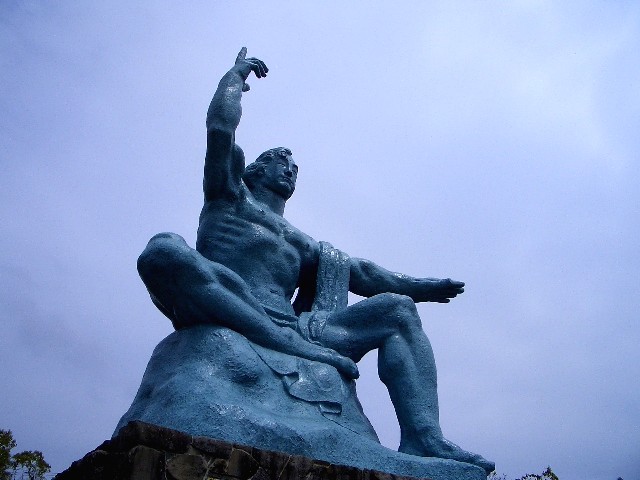 the statue is posed in a pose on a rock