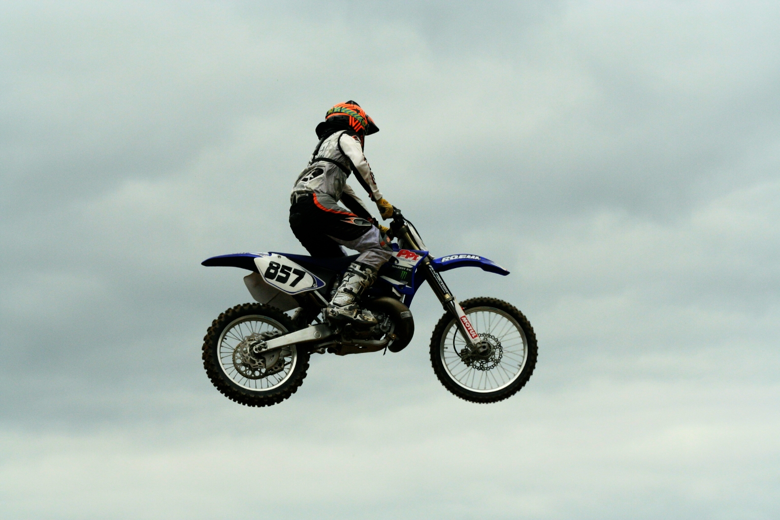 a person in full gear riding on top of a motorcycle