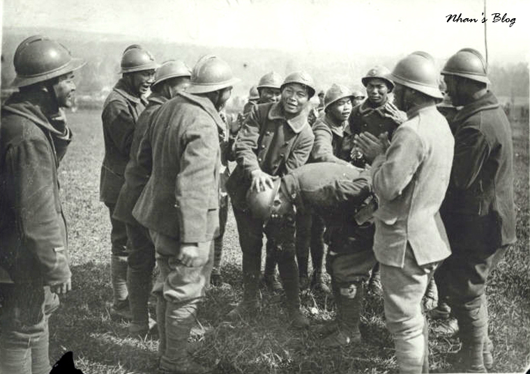 some soldiers standing around an old po of a soldier on horseback
