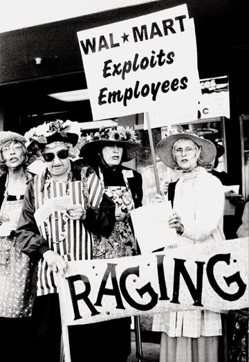 a group of women in matching dress standing holding signs