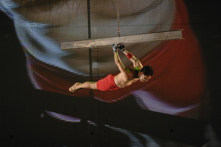 a man in a red shorts does aerial stunt