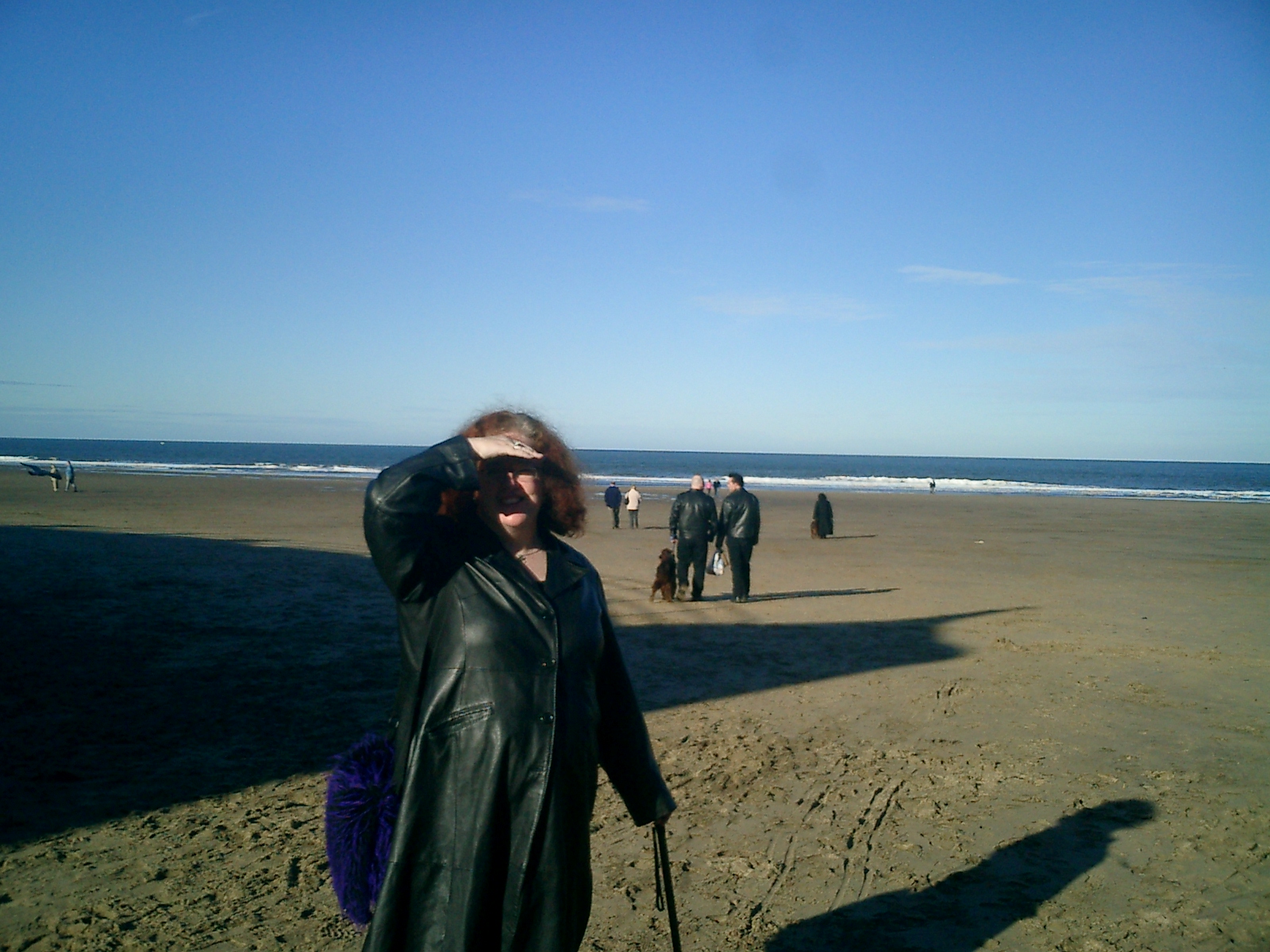 an older man on the beach with his shadow in the air