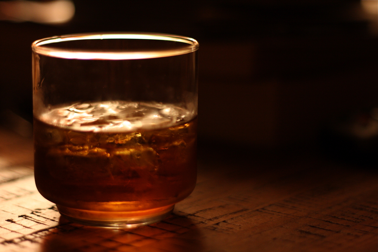 closeup of glass of beverage on wood surface