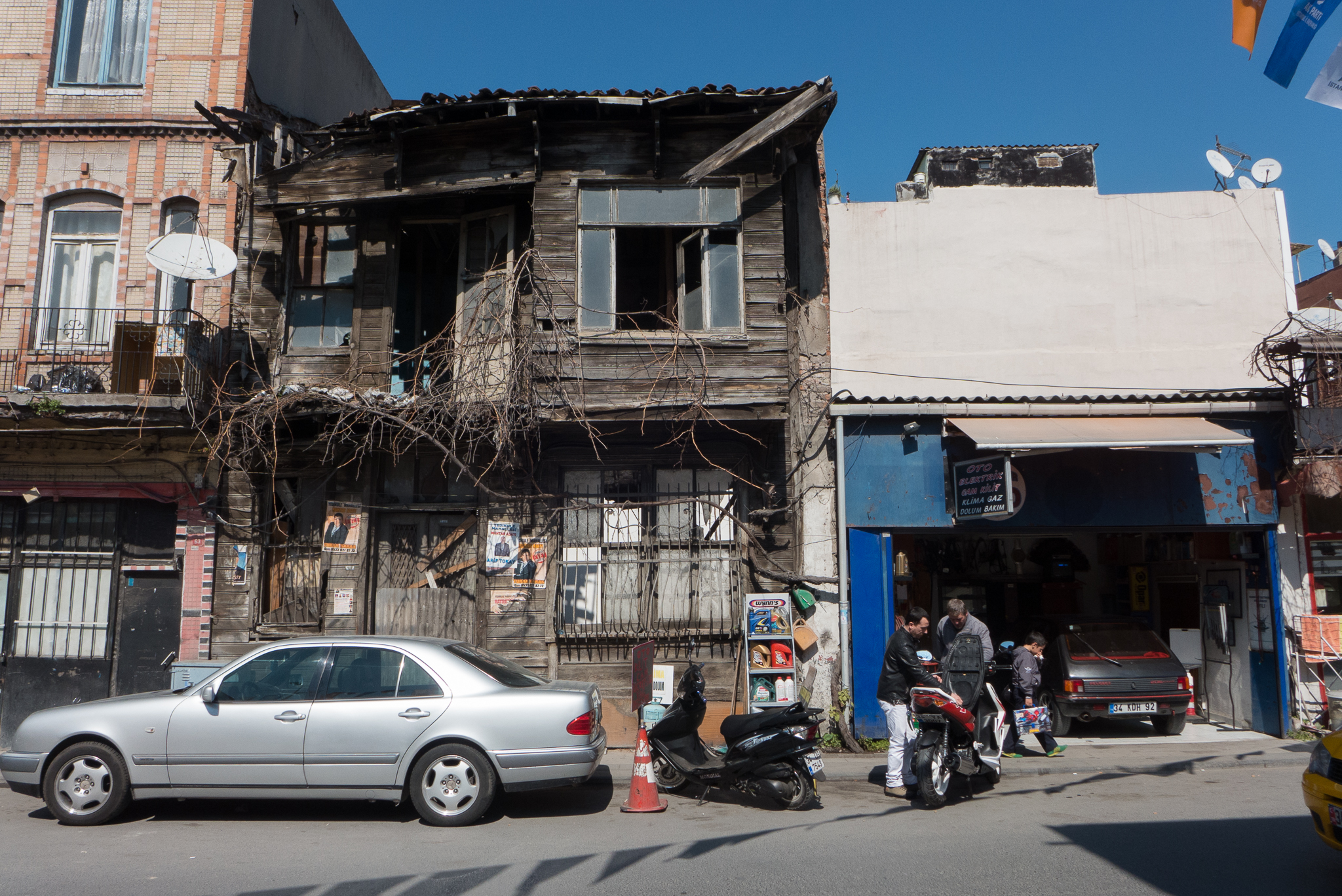 a street view with an old building and cars parked on the side