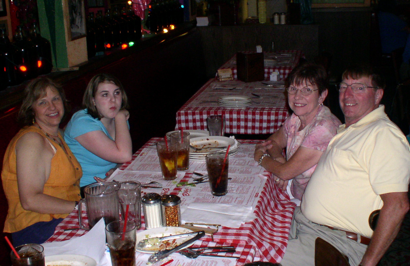 four people at a table with plates and drinking glasses