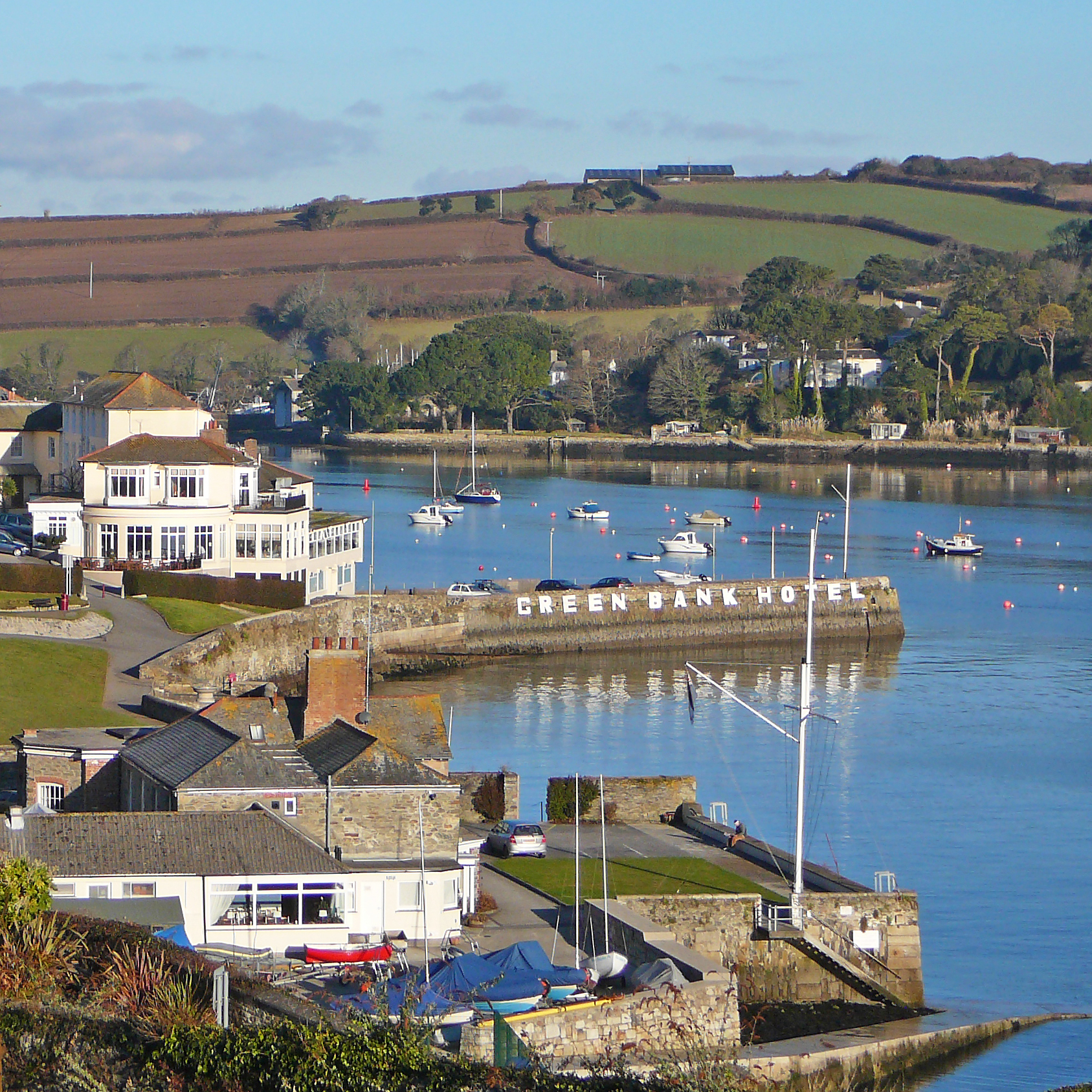 a marina is next to some houses with docked sailboats