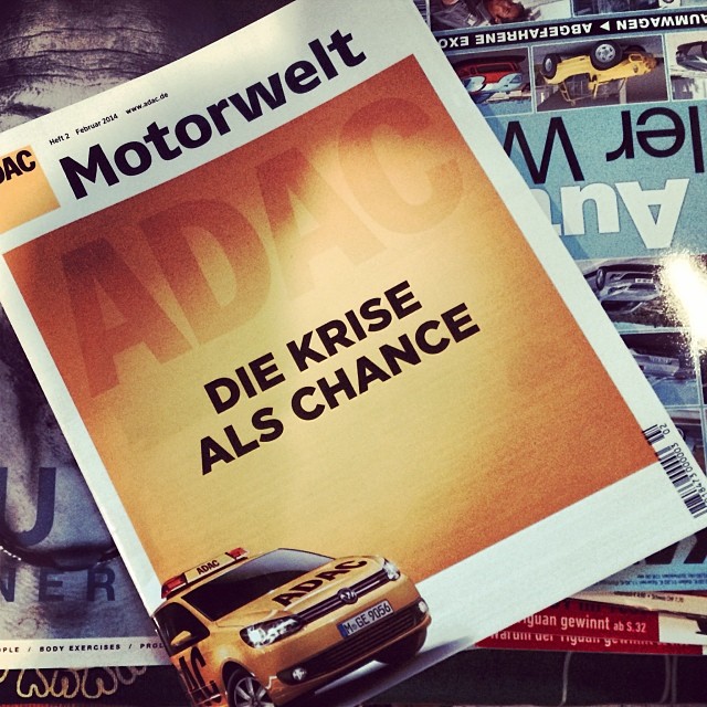 a pograph of a magazine front with a car in the middle