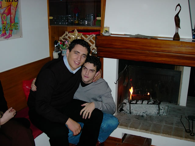 two friends having fun in a cozy room by the fireplace