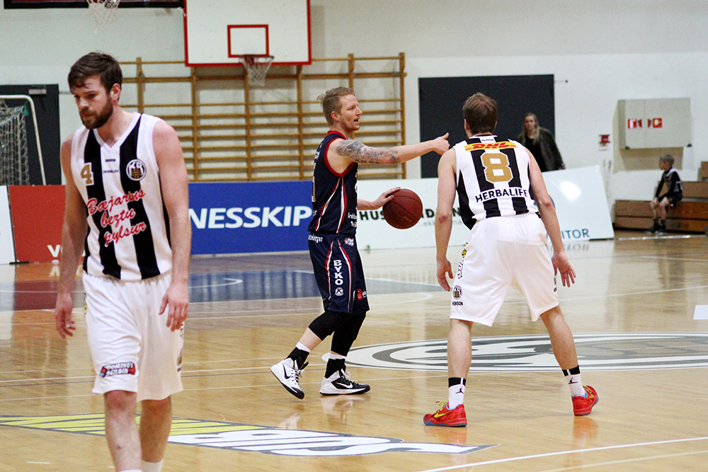 two basketball players are on the court playing basketball