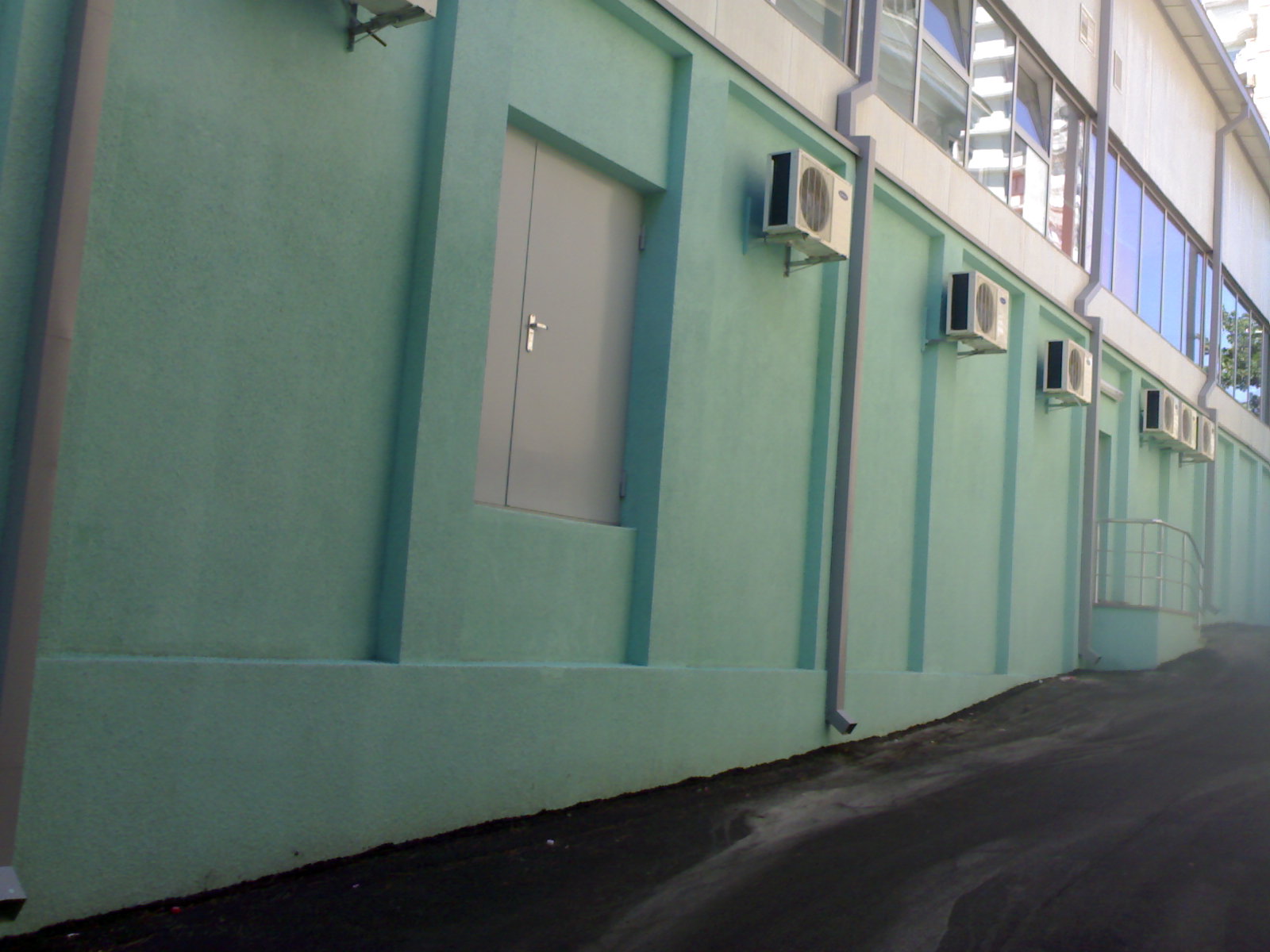 a small white door sitting on the side of a building