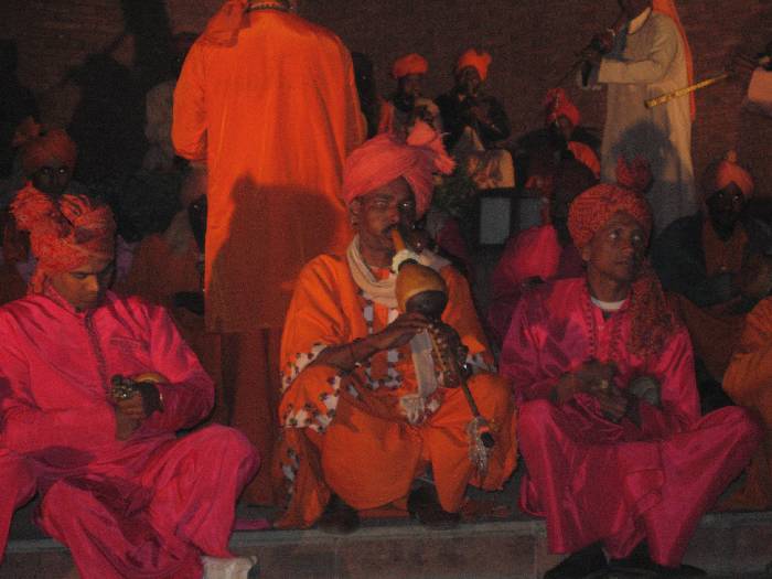 a group of people in orange and pink outfits