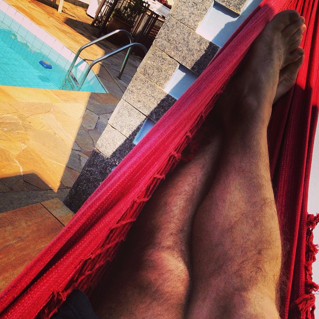 the legs and ankles of someone who is lying on a hammock