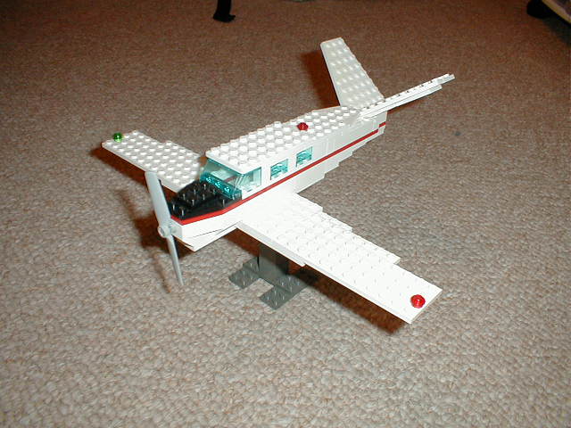 a toy white airplane is on the ground