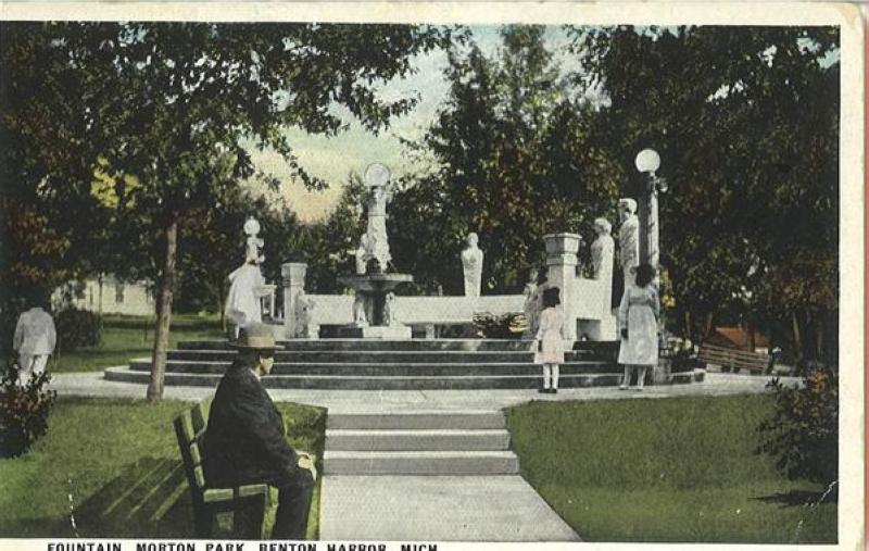 an old postcard depicting a woman sitting on a park bench