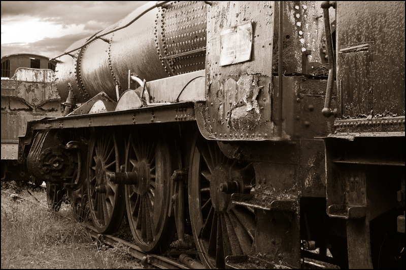 black and white image of old rusty train cars