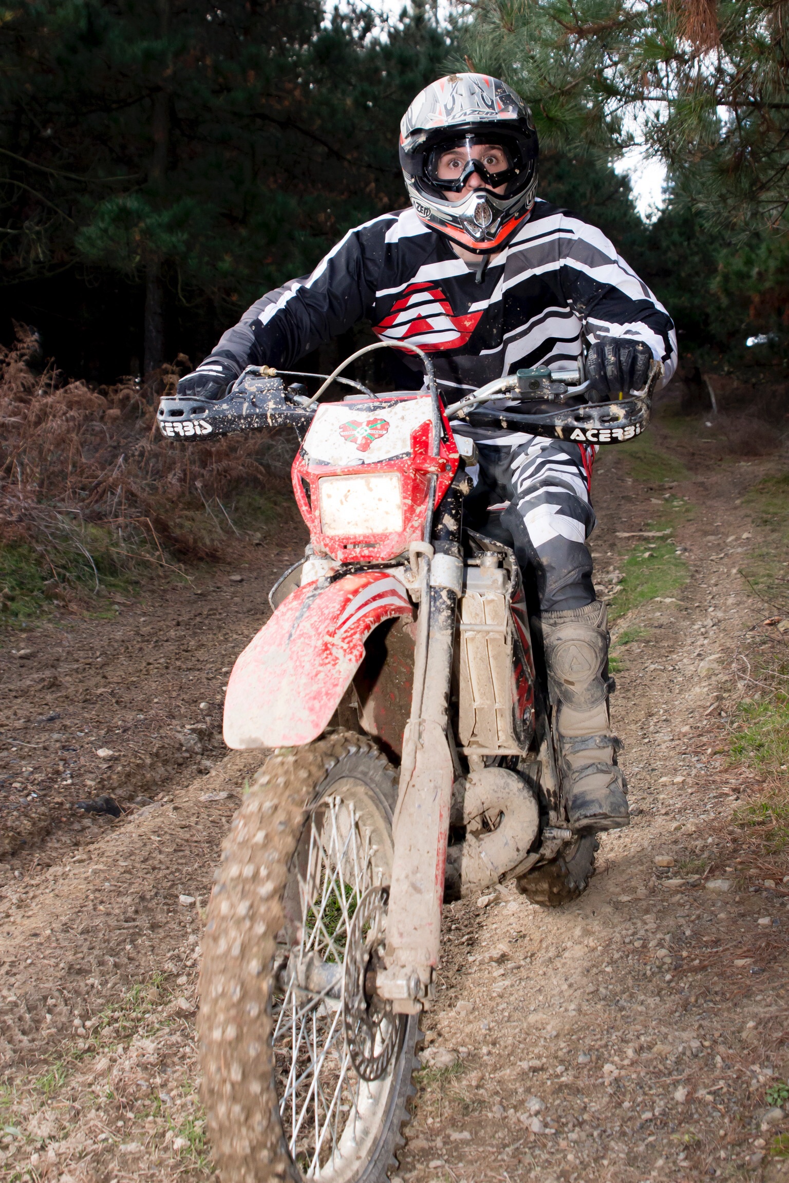 the motorcycle is traveling up a dirt trail