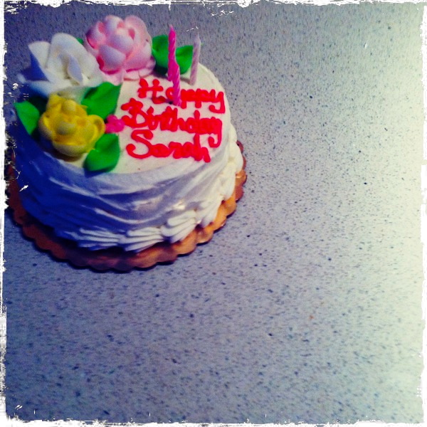 a decorated birthday cake sitting on top of a table