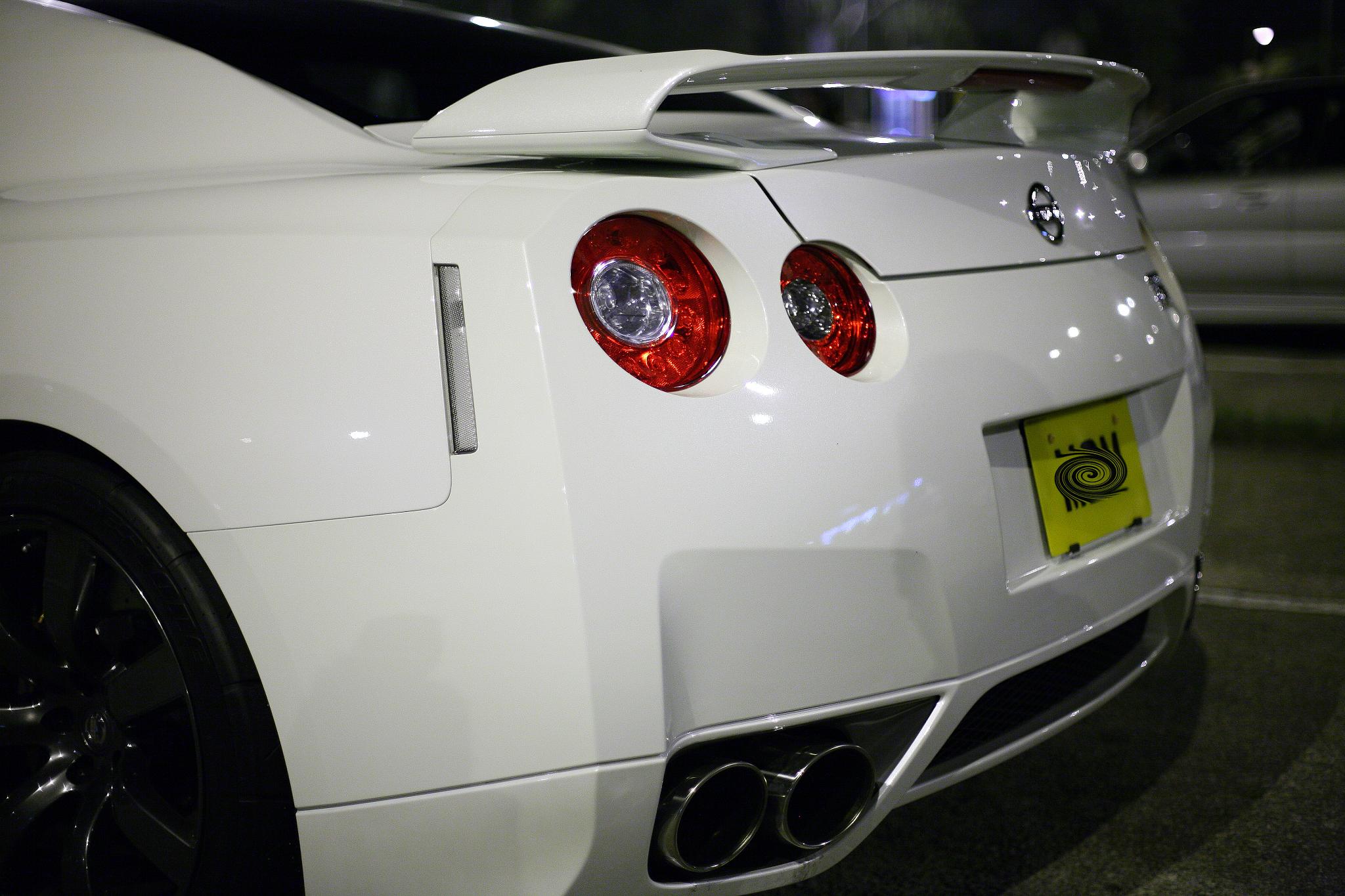 a white sports car parked next to a building