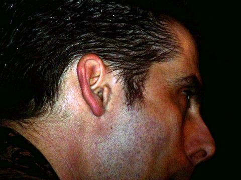 man has the ear piercing on his ear