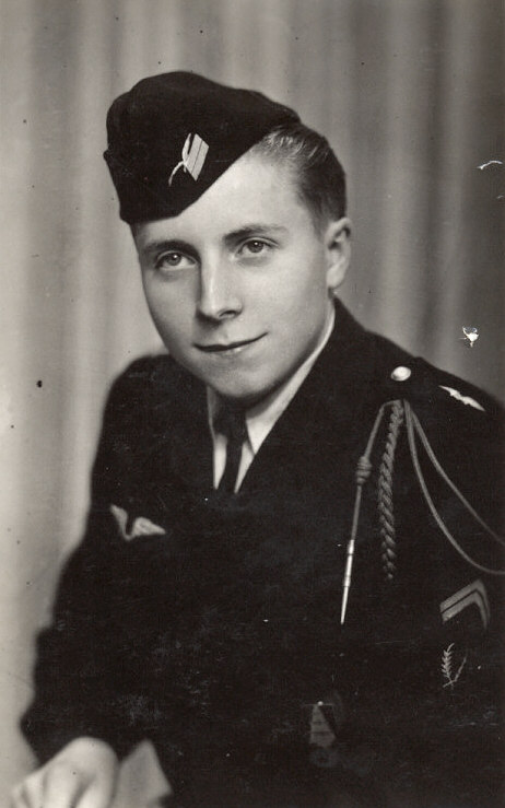 the man is dressed in a navy uniform and holding a pencil