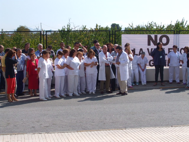 a group of people in white standing outside together