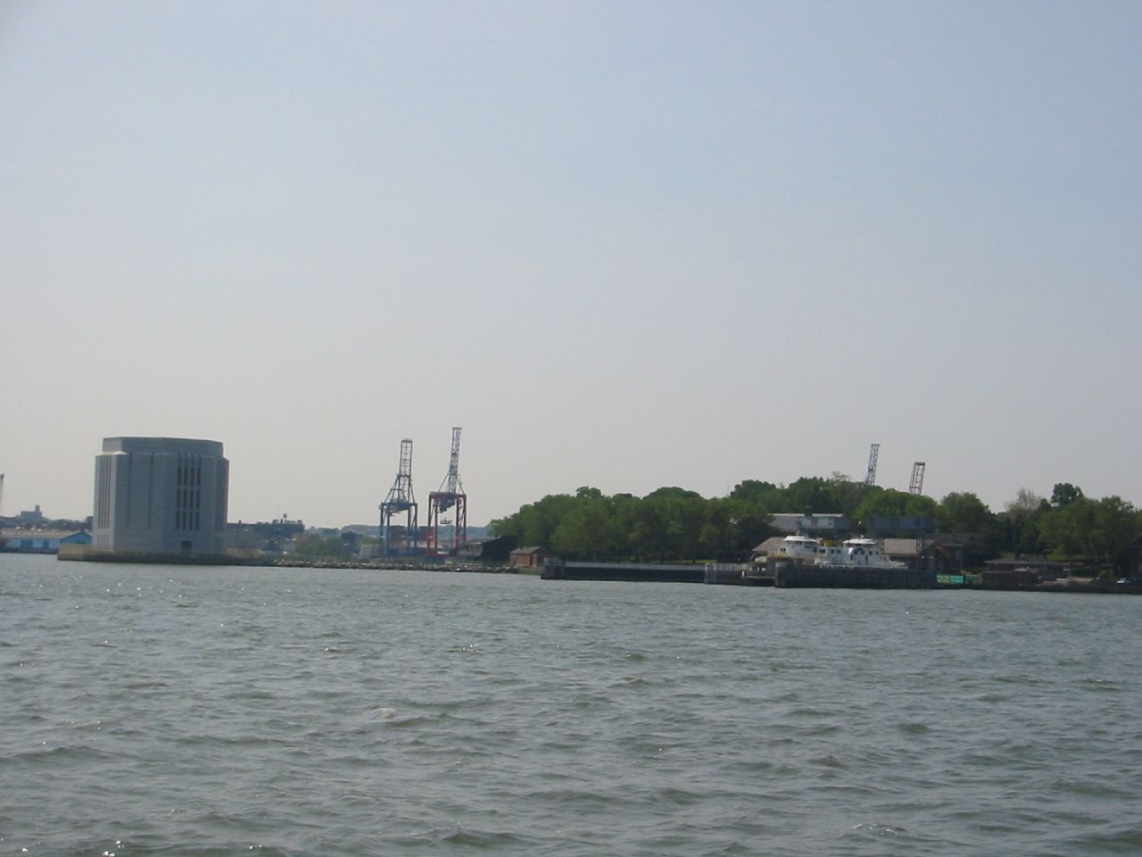 a view of the harbor with industrial buildings on the shoreline