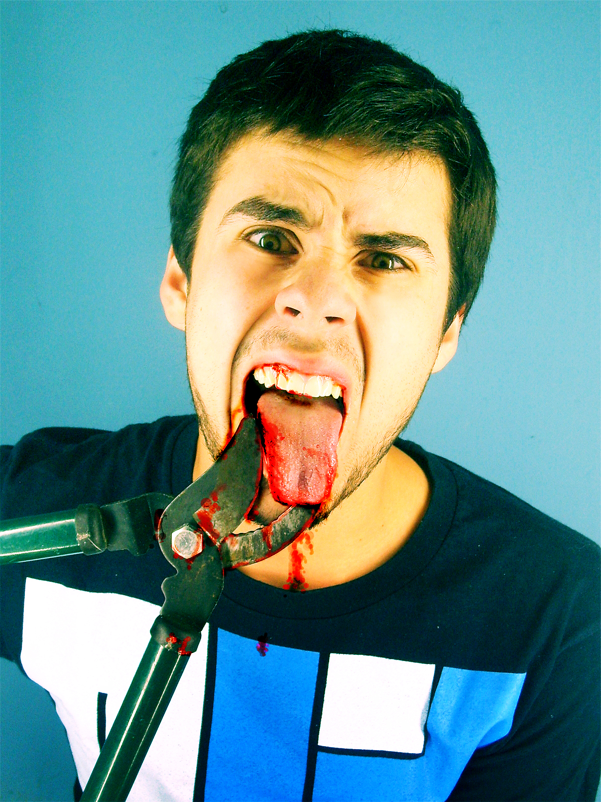 a man with his tongue out and his mouth covered by his knife