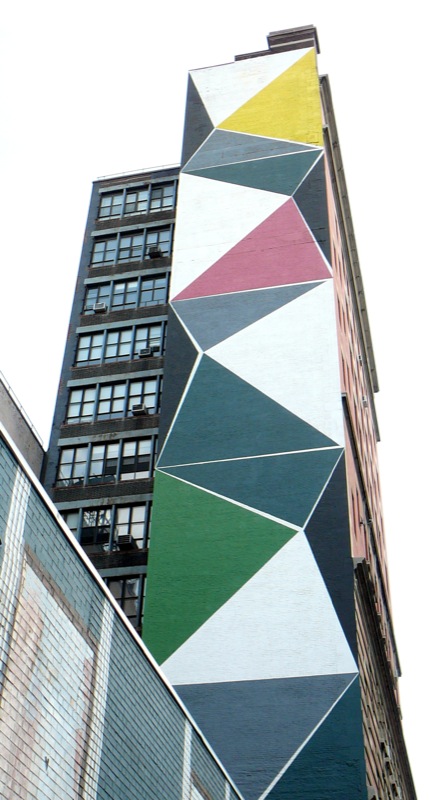 a building is covered in colorful designs on the side