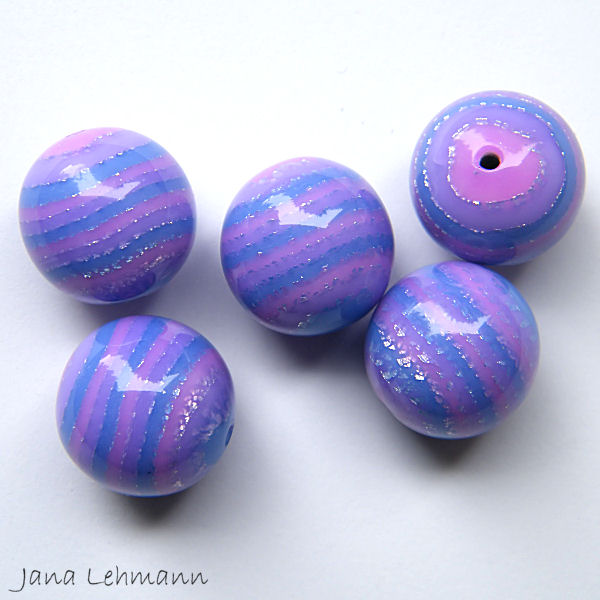 blue and purple bead with a star, a bird and some bubbles on it