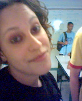 a woman looks at the camera in a classroom