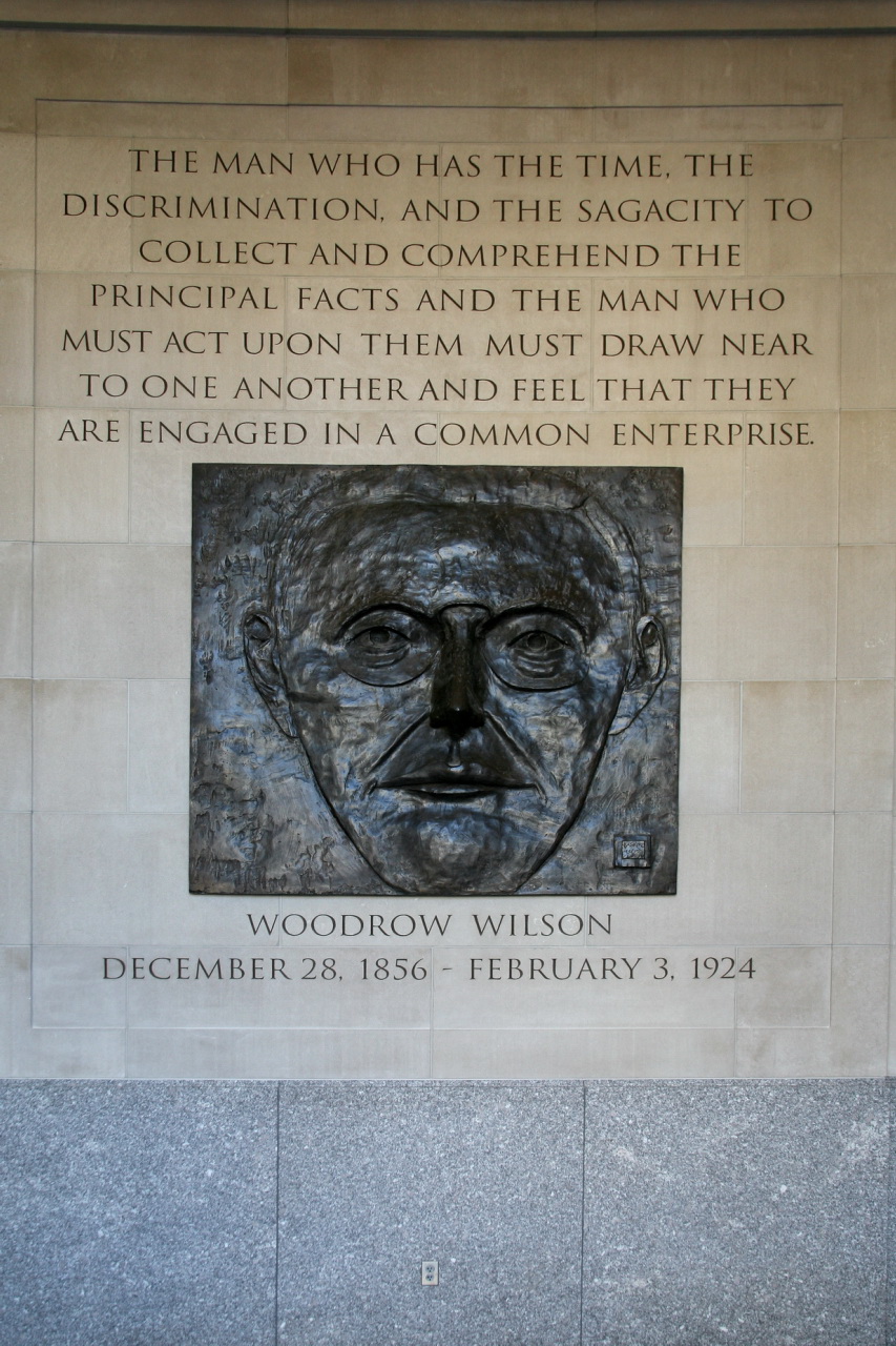 a busture of a man, next to a plaque