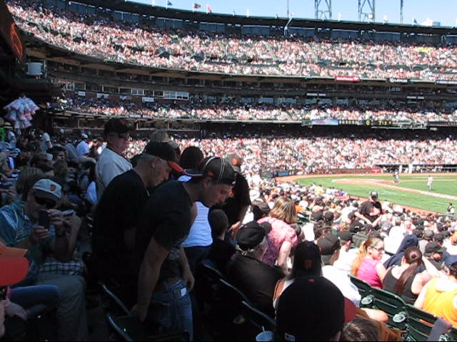 baseball fans are sitting in the stands at a game