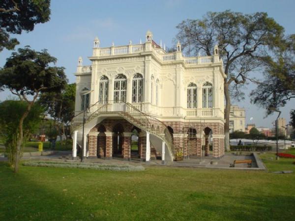 a large building in a park with a stairway leading to the top