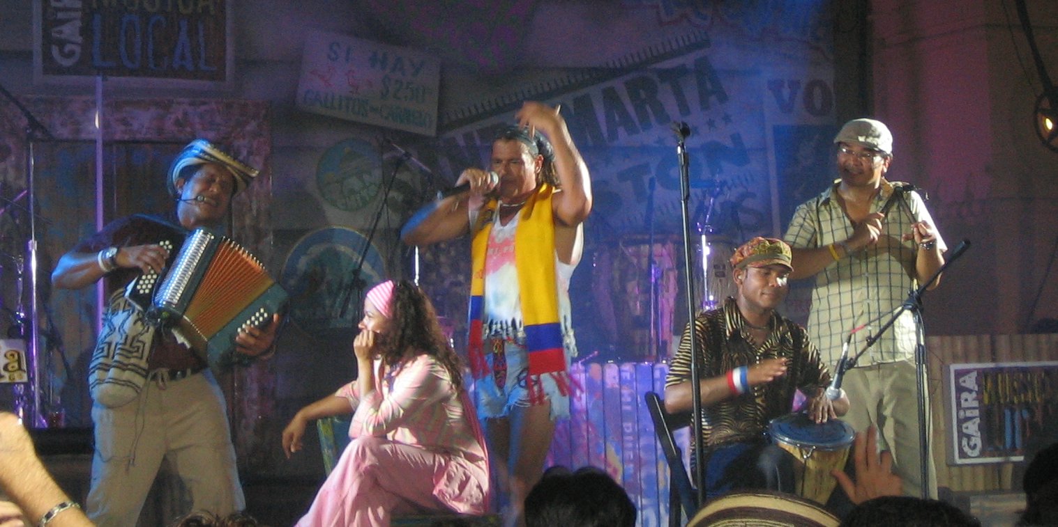 a group of people performing on stage with music instruments