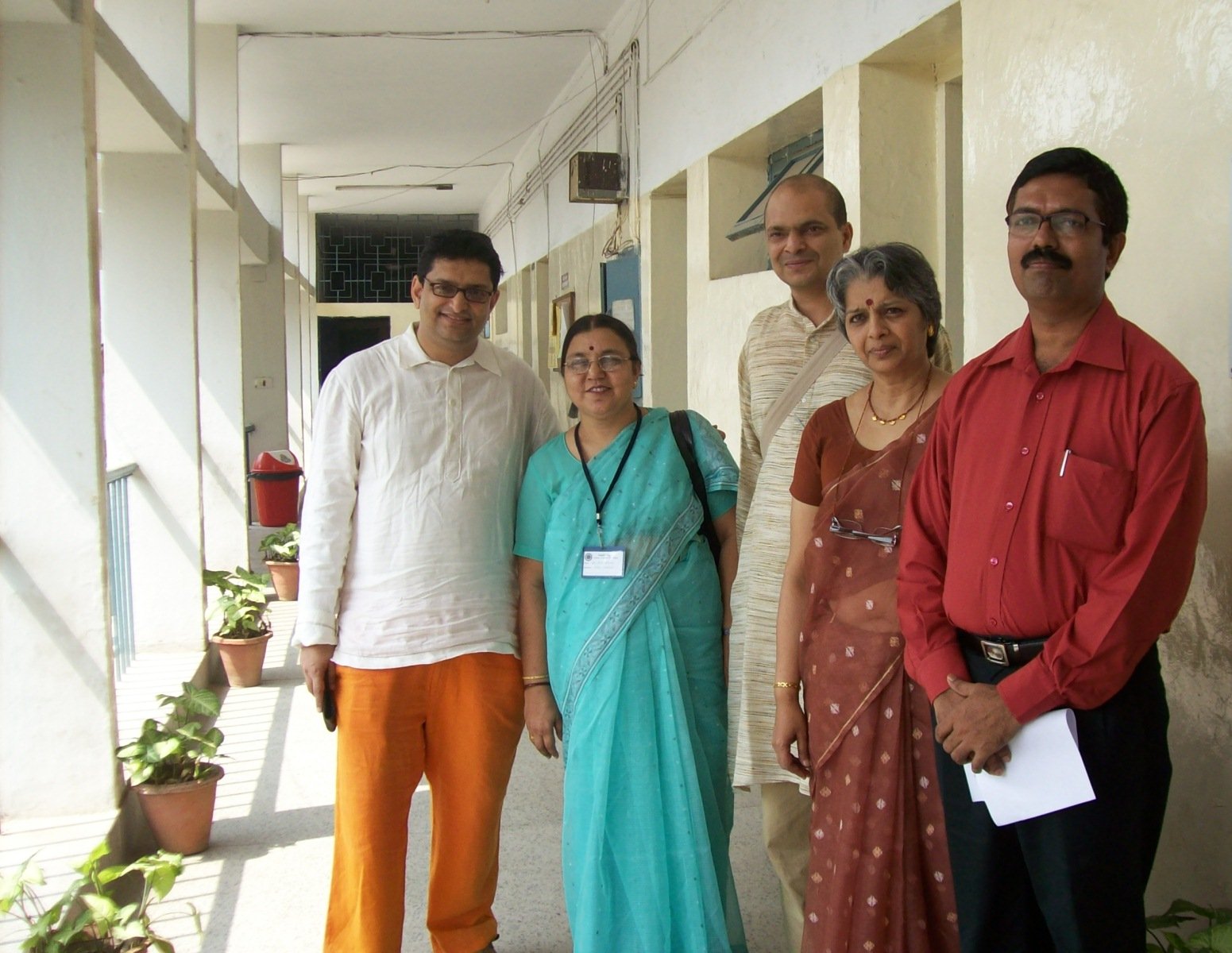 a family is standing in an hallway and looking at the camera